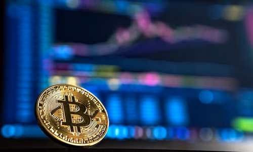 A secure hardware wallet displaying a Bitcoin transaction confirmation, sitting on a wooden desk next to a notebook.