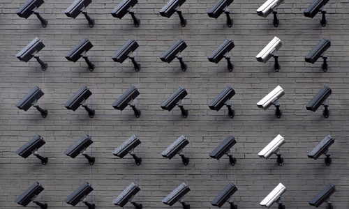 CCTV security cameras on a building wall representing India's ban on Chinese surveillance cameras from Hikvision and Dahua effective April 1 2026