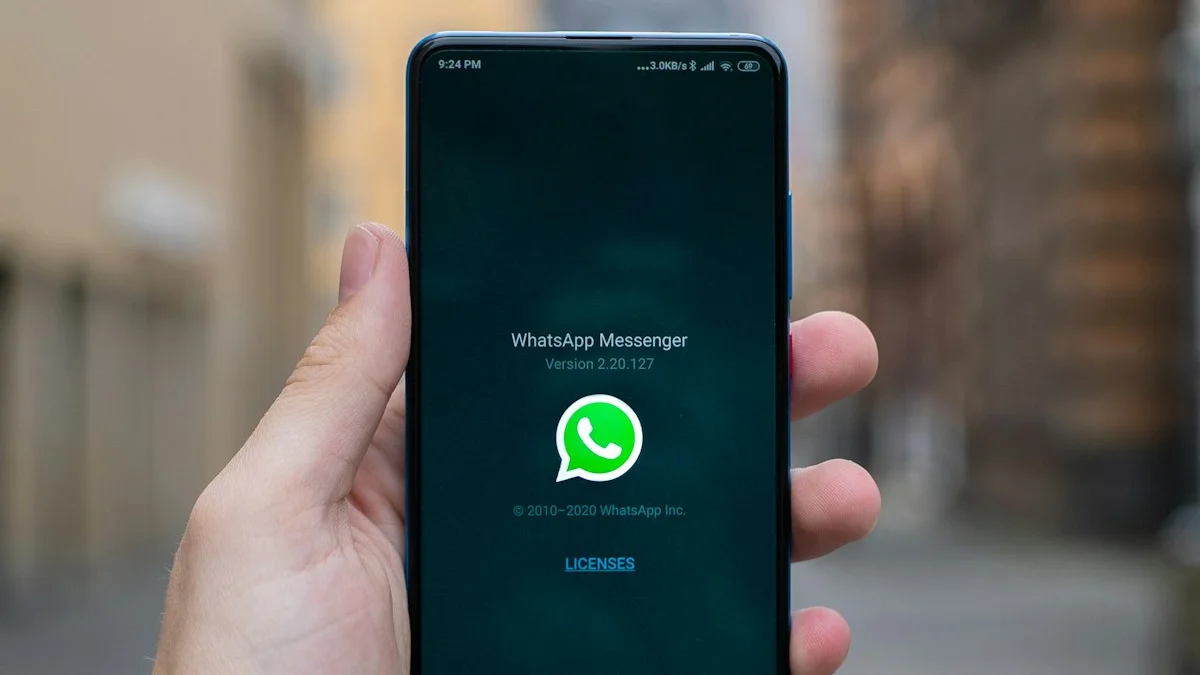 WhatsApp logo on a smartphone with a security alert icon