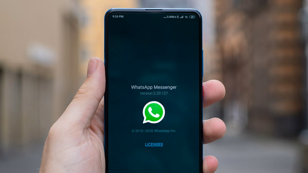 WhatsApp logo on a smartphone with a security alert icon