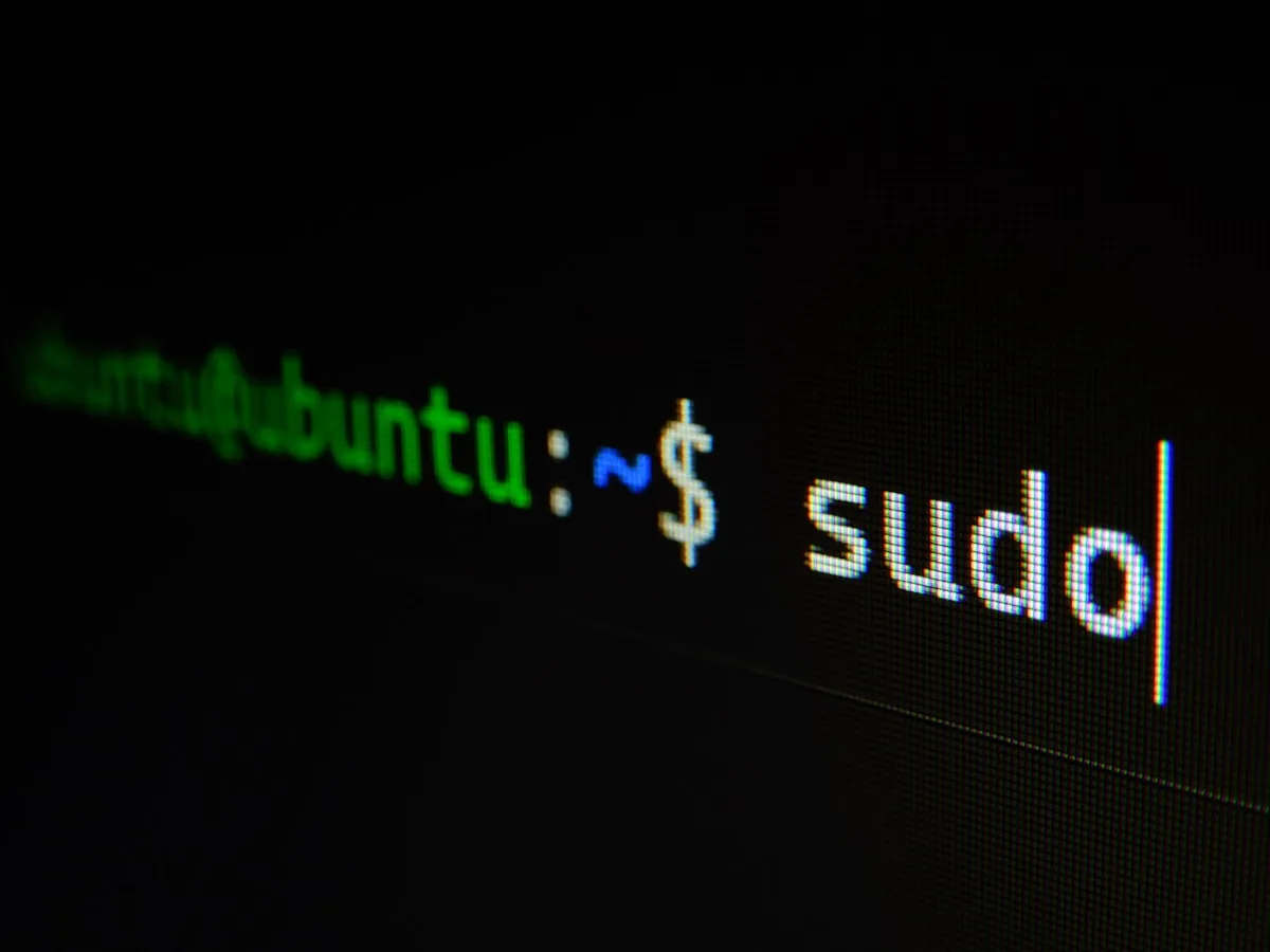 A laptop screen displaying the Linux terminal with a privacy-focused distribution logo, representing the switch to an open-source, sovereign operating system.