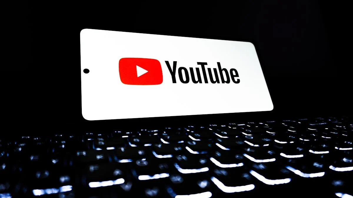 Smartphone showing YouTube and Gmail app icons on screen representing YouTube Premium price increase and Gmail end-to-end encryption announcement April 2026