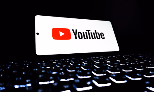 Smartphone showing YouTube and Gmail app icons on screen representing YouTube Premium price increase and Gmail end-to-end encryption announcement April 2026