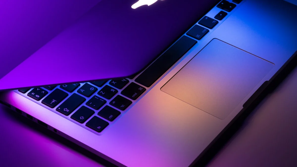 Apple MacBook Pro laptop on a dark surface representing the upcoming M6 chip 2nm OLED MacBook Pro expected at WWDC 2026
