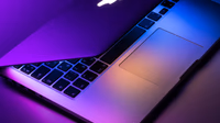 Apple MacBook Pro laptop on a dark surface representing the upcoming M6 chip 2nm OLED MacBook Pro expected at WWDC 2026