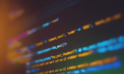 A developer's dual-monitor workstation with code on one screen and AI model output on the other, bathed in soft blue light — representing the local open-source AI development environment where models like Gemma 4 and Llama 4 Scout run entirely on personal hardware without sending data to external servers.