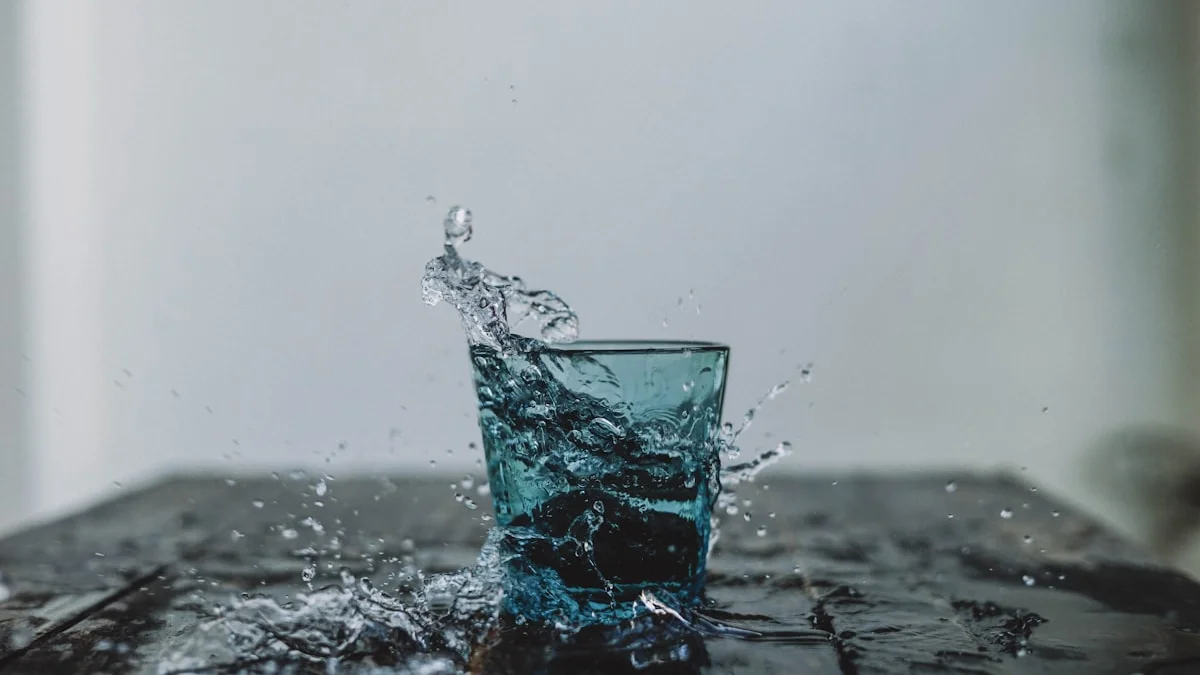 A clean, minimalist glass of water on a dark background, representing the purity and privacy of Aura Water's design.