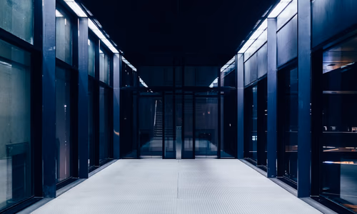 A close-up of server racks with glowing blue lights, representing cloud and chip investment.
