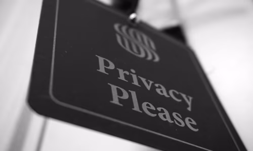 A glowing digital cyber security shield representing AI governance and data privacy controls.