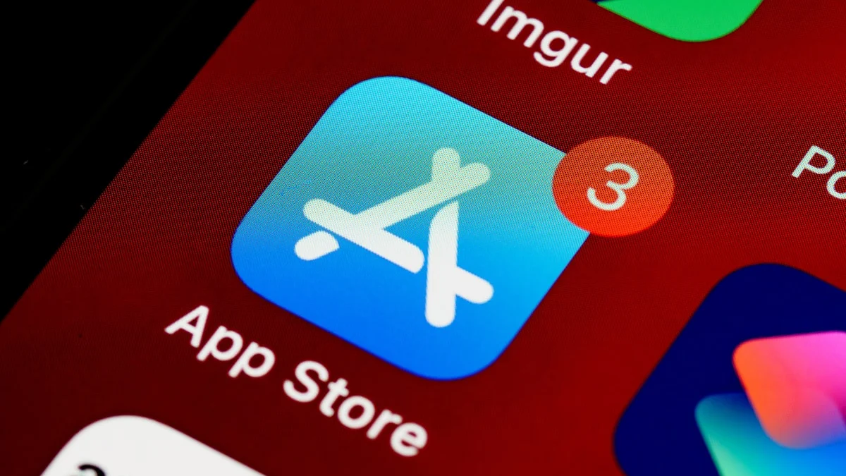 Smartphone showing the App Store with a blurred Apple logo in the background