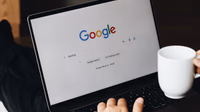 A person viewing a search results page with overlaid AI text and warning icons.