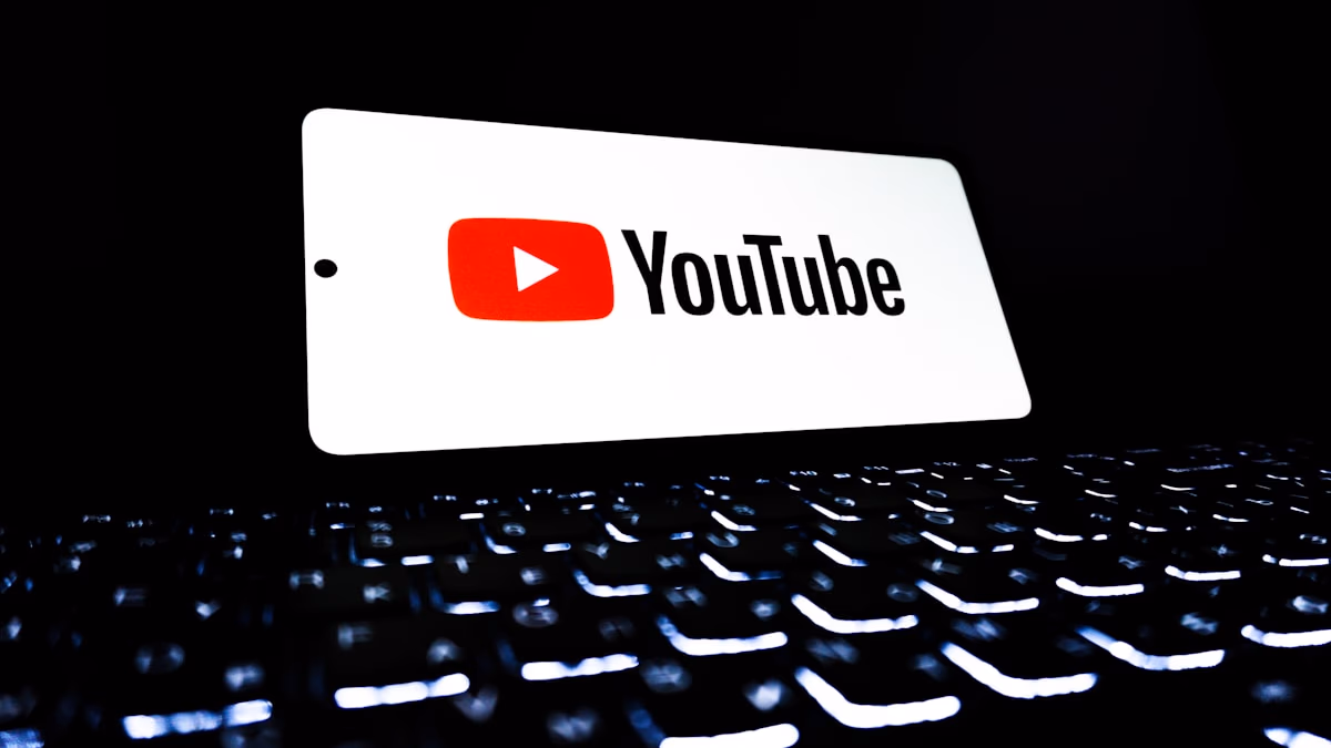 Smartphone showing YouTube and Gmail app icons on screen representing YouTube Premium price increase and Gmail end-to-end encryption announcement April 2026