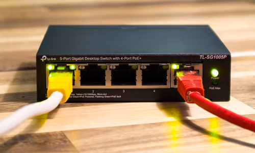 Network router cables representing telecommunications infrastructure.